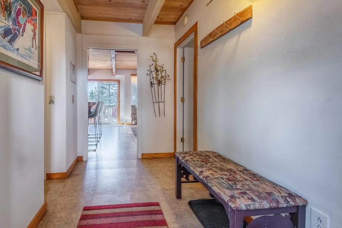 Hallway with an upholstered bench leading to the living area, Lakeview Serenity Cottage