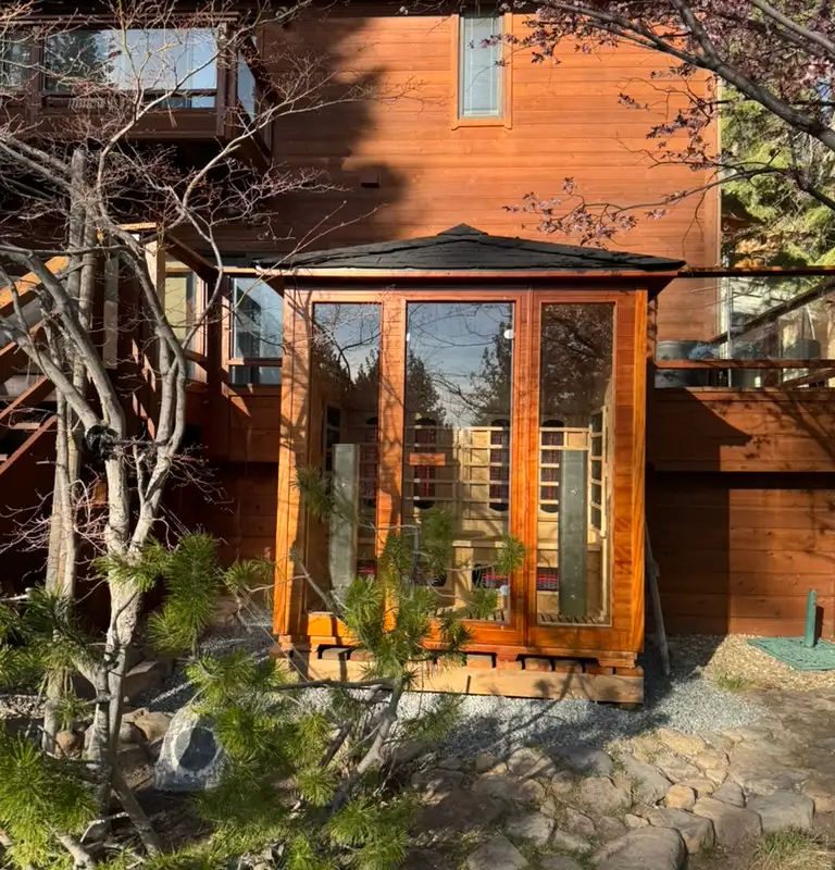Glass-front outdoor sauna cabin among trees, Incline Lakeside Haven