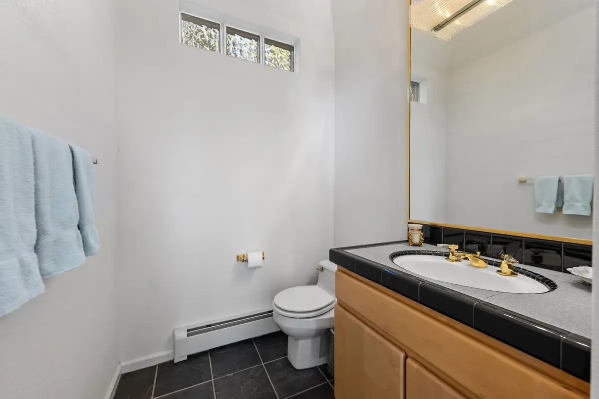 Bathroom with tiled vanity and high windows, 90s Tahoe Time Capsule