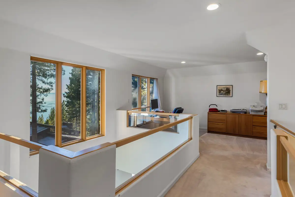 Upstairs landing with railing and tall windows, 90s Tahoe Time Capsule