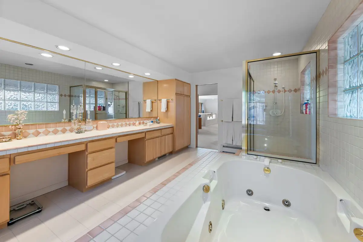 Bathroom with jetted tub, long vanity and glass shower, 90s Tahoe Time Capsule