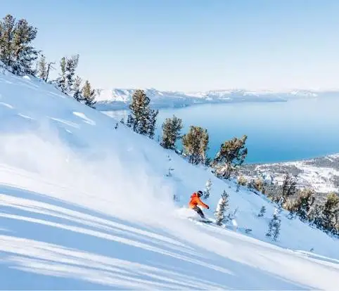 A skier on a groomed run above Lake Tahoe