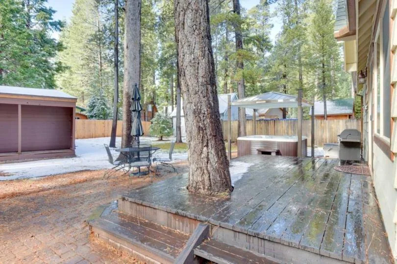 Outdoor seating and dining on the deck at Tranquil Trails Cabin in Tahoma